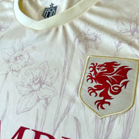 Cymru Cennin Pedr Away Football Jersey woven crest detail off white standard fit performance fabric available @ asphaltscialklub.com 